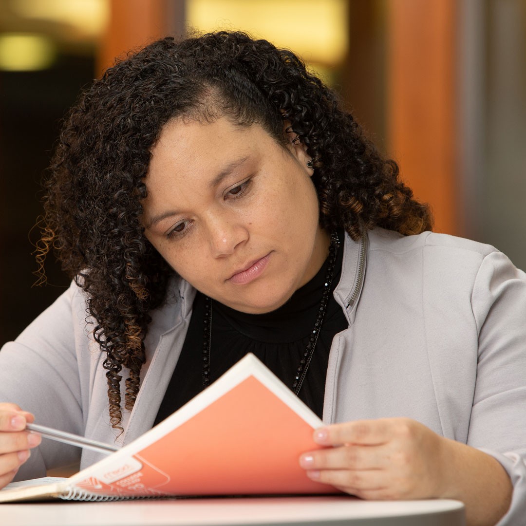 a woman studies a notebook