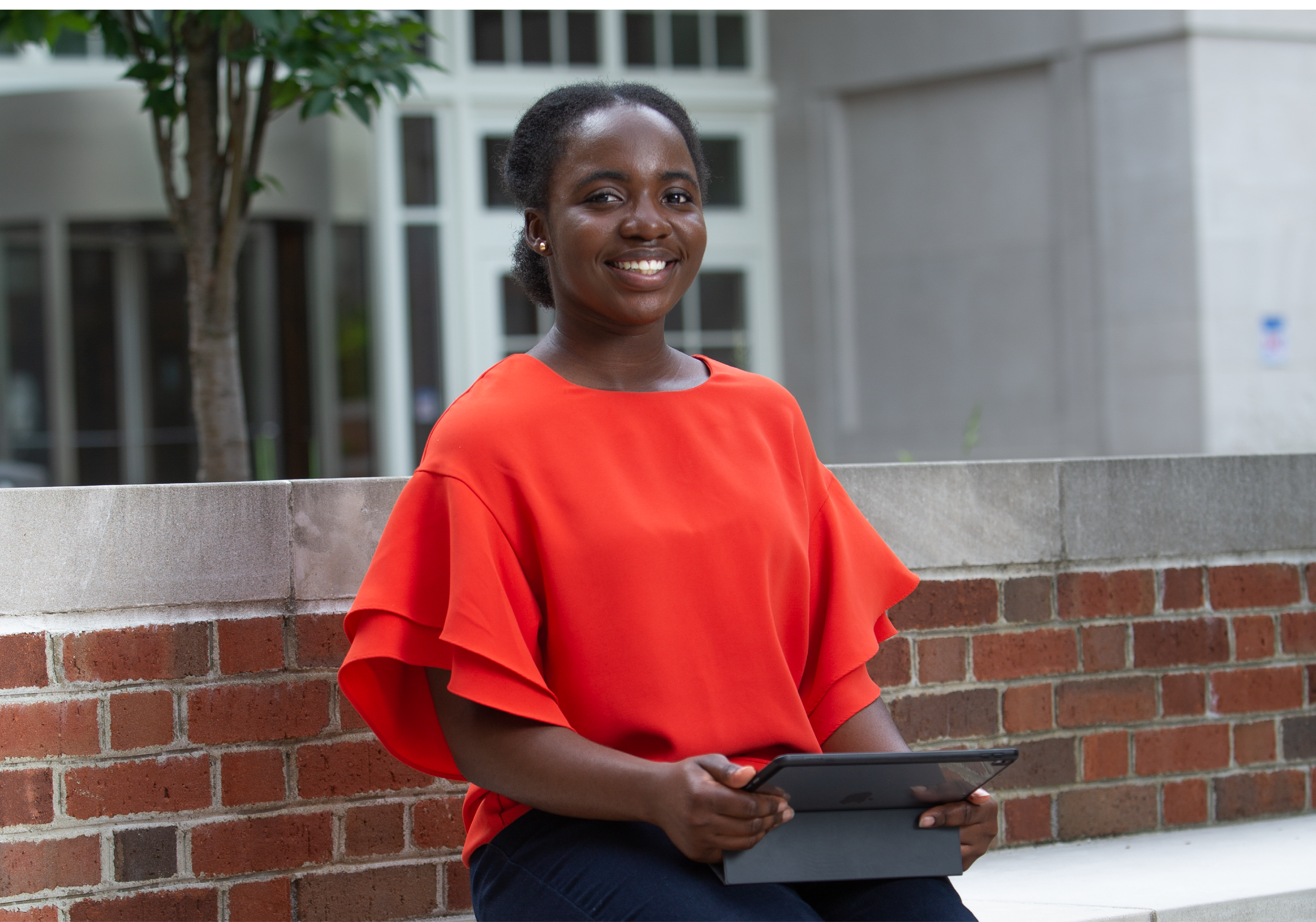 IT student on her computer in front of CECH